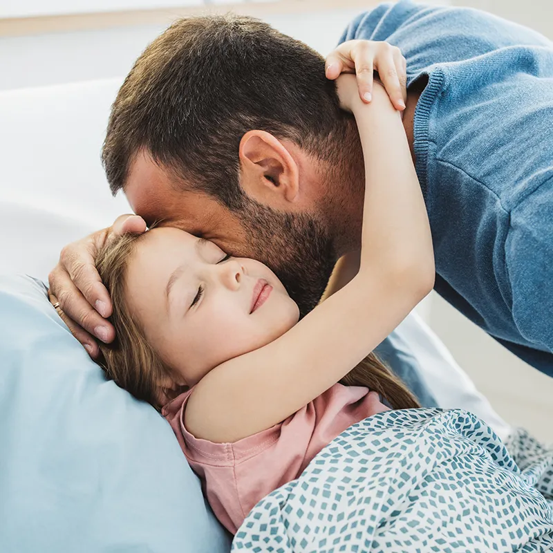 Father hugging sick child
