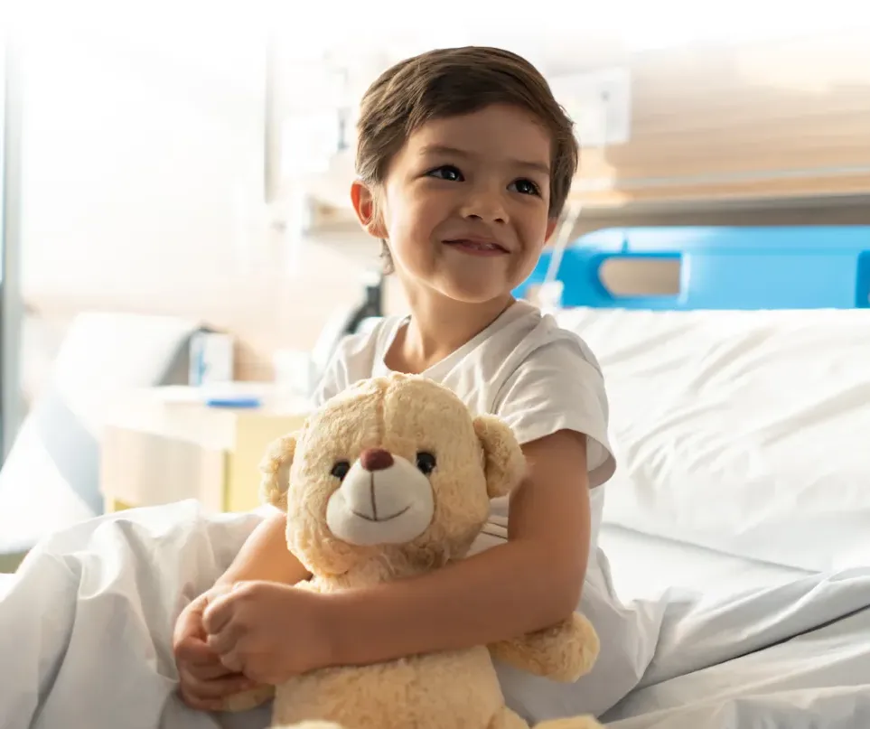 Sick boy hugging Teddy