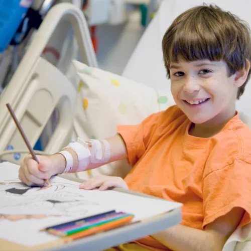 Boy coloring in hospital
