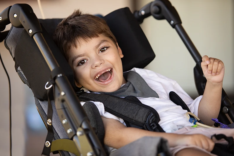 Smiling boy with cerebral palsy