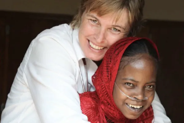 Doctor hugging sick child