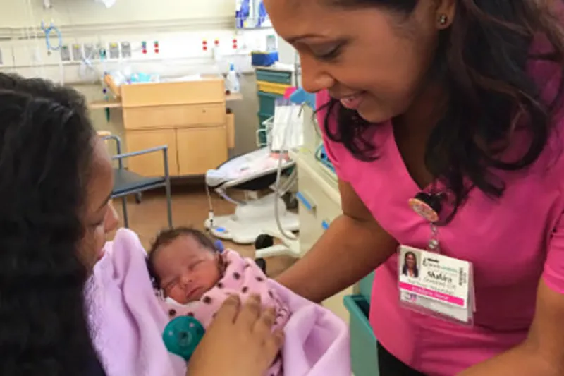 Mother holding baby in NICU
